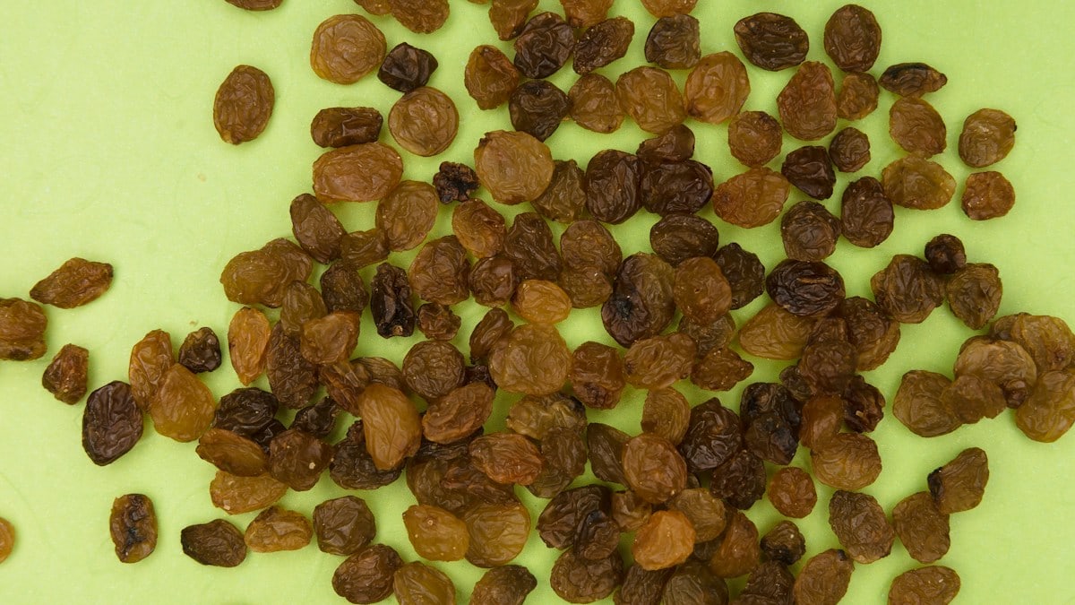 brown and black nuts on white surface